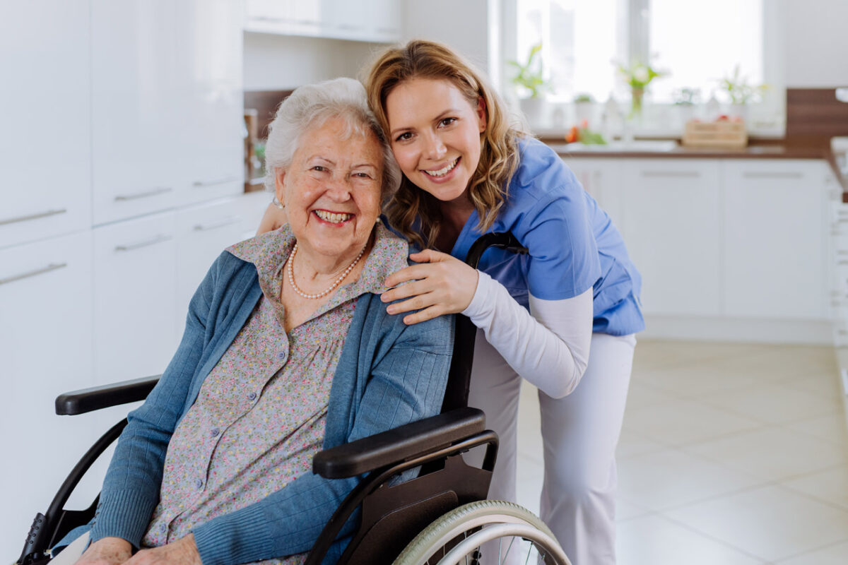Caregiver with elderly patient in wheelchair