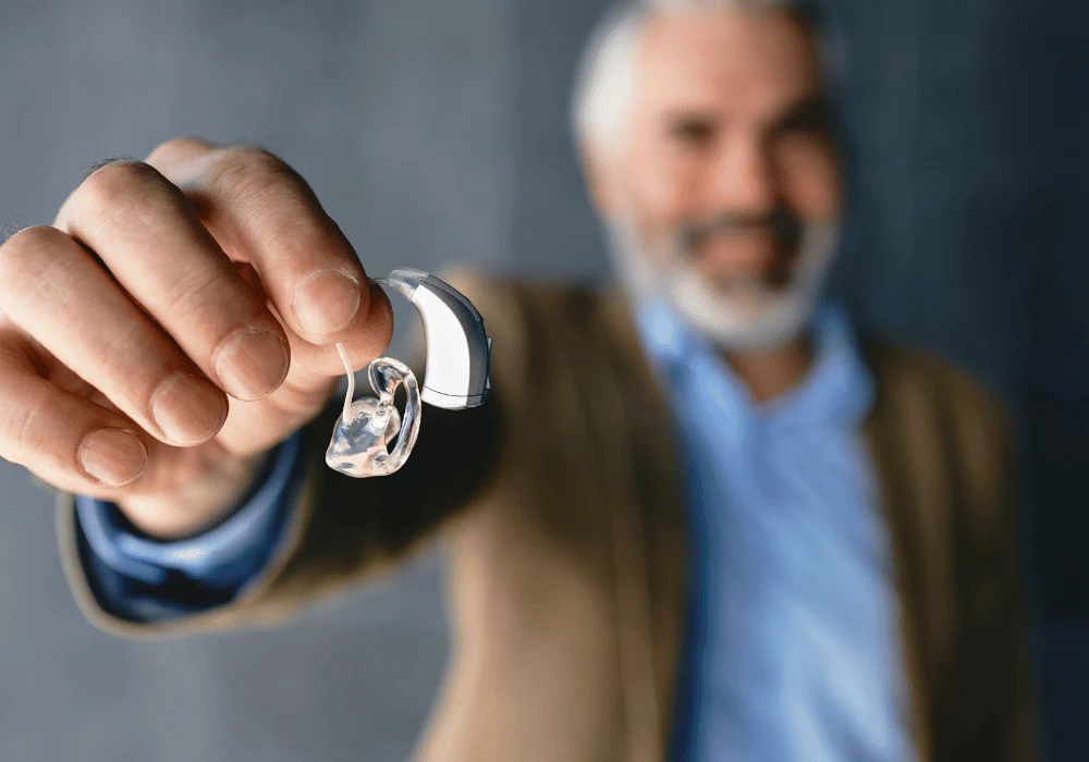 Man holding hearing aid