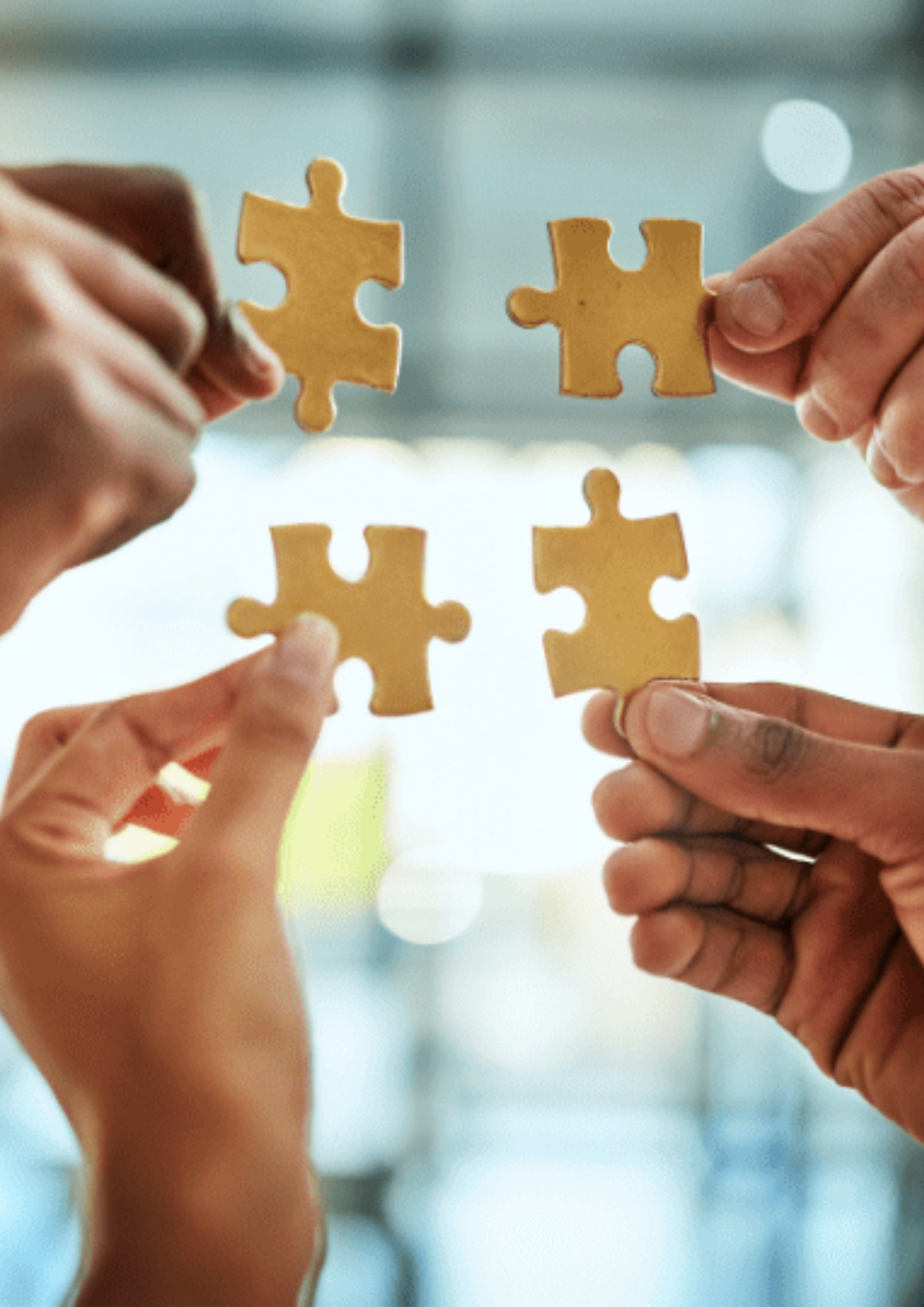 Hands assembling a colorful jigsaw puzzle