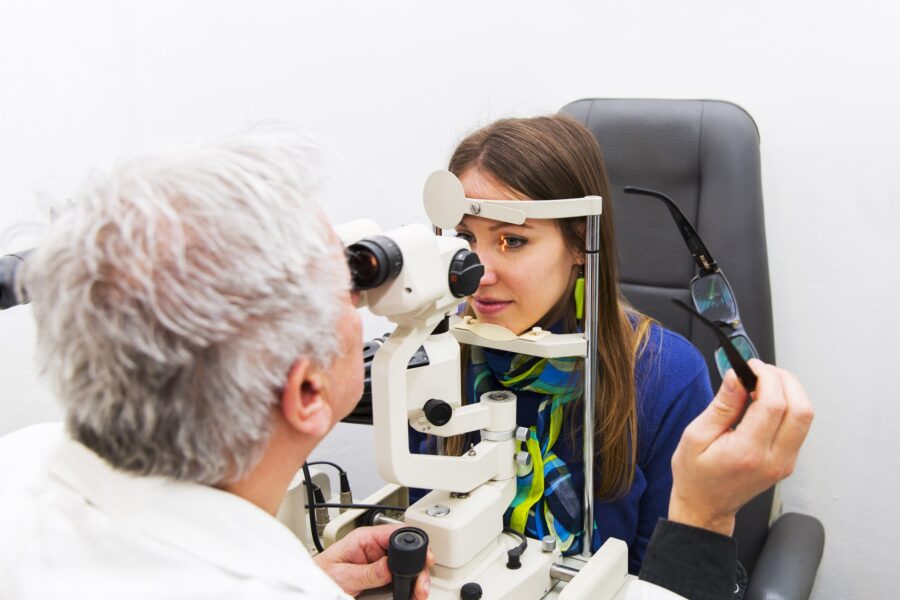 Young woman at the optometrist,doctor is checking her vision